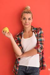 Image showing woman over color background plays with apple