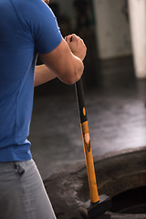 Image showing man workout with hammer and tractor tire