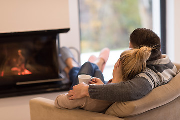 Image showing Young couple  in front of fireplace