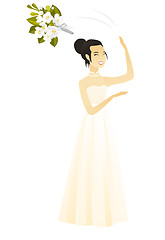 Image showing Asian bride tossing a bouquet of flowers.