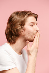 Image showing Portrait of attractive cute man with kiss isolated over pink background