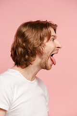 Image showing The man with crazy expression isolated on pink