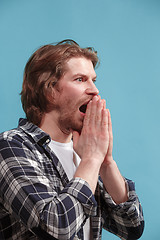 Image showing Beautiful man in stress isolated on blue