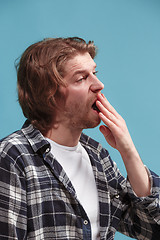 Image showing Beautiful bored man bored isolated on blue background