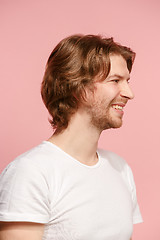 Image showing The happy businessman standing and smiling against pink background.