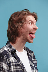 Image showing The man with crazy expression isolated on blue
