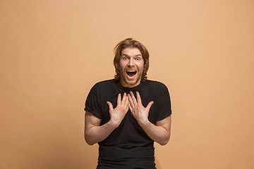 Image showing Handsome man looking suprised isolated on pastel