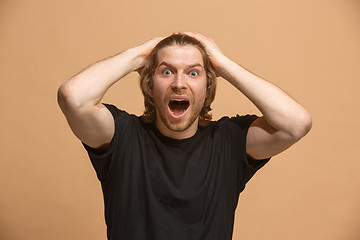 Image showing Handsome man looking suprised isolated on pastel