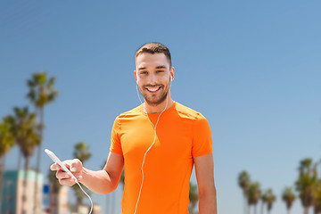 Image showing man with smartphone and earphones in los angeles