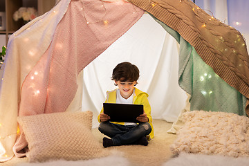 Image showing little boy with tablet pc in kids tent at home