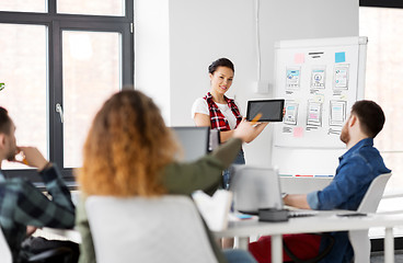 Image showing woman showing tablet pc to creative team at office