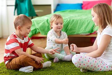 Image showing kids playing rock-paper-scissors game at home