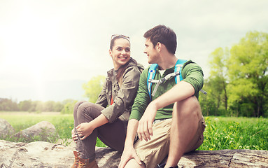 Image showing smiling couple with backpacks in nature