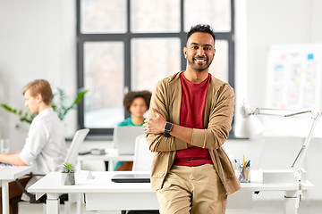 Image showing smiling indian man with smart watch at office