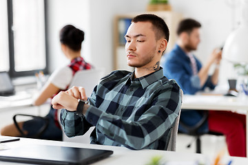 Image showing creative man with smart watch working at office