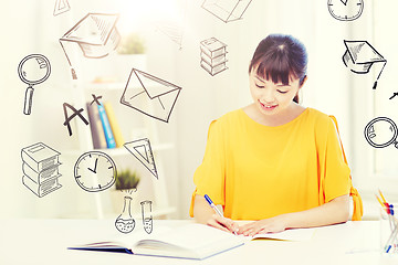 Image showing happy asian young woman student learning at home