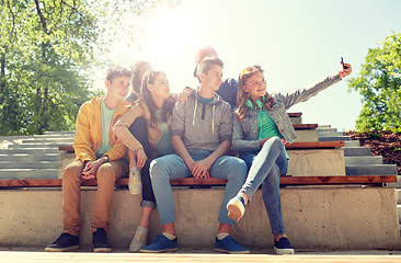 Image showing happy teenage students taking selfie by smartphone