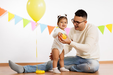 Image showing father and daughter with birthday party balloon