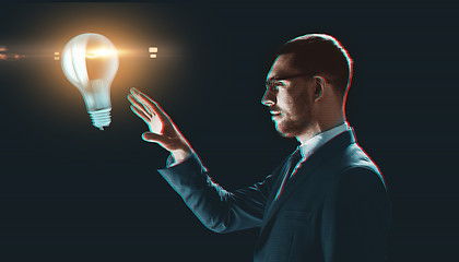 Image showing businessman with virtual light bulb projection