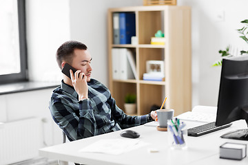 Image showing creative male calling on smarphone at office