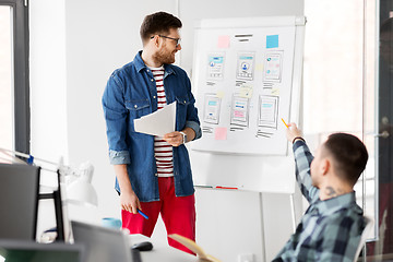 Image showing creative man showing user interface at office