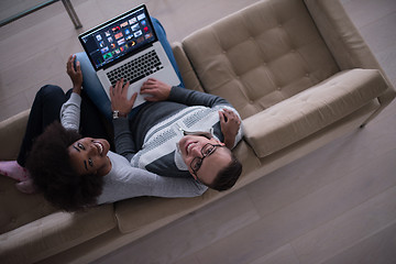 Image showing happy multiethnic couple relaxes in the living room