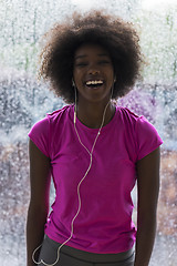 Image showing portrait of young afro american woman in gym while listening mus