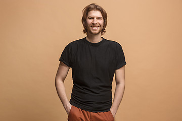 Image showing The happy business man standing and smiling against pastel background.