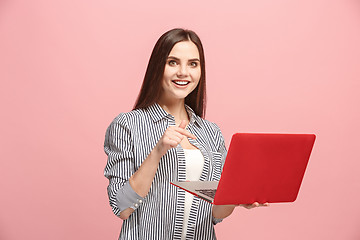 Image showing Businesswoman with laptop on pink studio