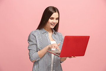 Image showing Businesswoman with laptop on pink studio
