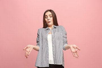 Image showing Beautiful female half-length portrait isolated on pink studio backgroud. The young emotional surprised woman