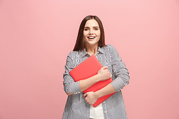 Image showing Businesswoman hugging laptop on pink studio