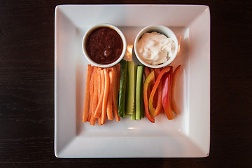 Image showing Fresh carrot cucumber pepper and two sauce