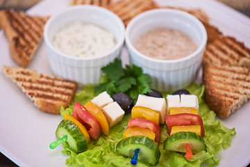 Image showing toast with cheese vegetables and olive on the stick
