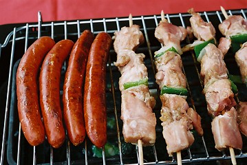 Image showing Sausages and kebab on Barbecue BBQ grill