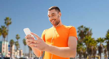 Image showing man with smartphone and earphones in los angeles