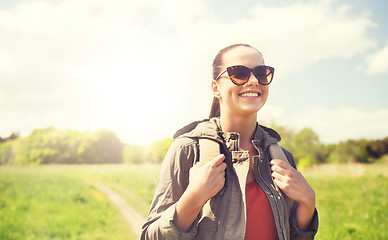 Image showing happy young woman with backpack hiking outdoors