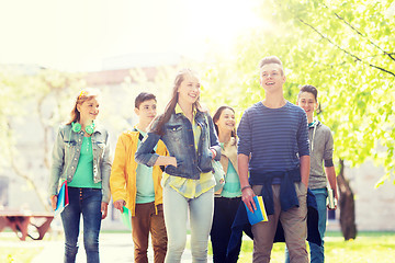 Image showing group of happy teenage students walking outdoors