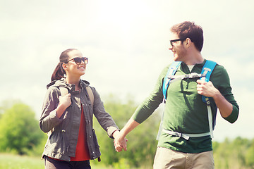 Image showing happy couple with backpacks hiking outdoors