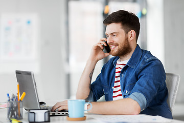 Image showing creative man calling on smarphone at office