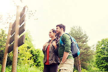 Image showing smiling couple with backpacks hiking