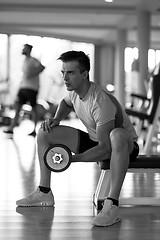 Image showing handsome man working out with dumbbells