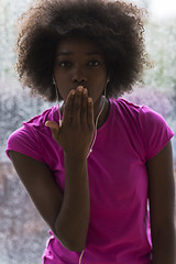 Image showing portrait of young afro american woman in gym while listening mus