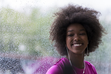 Image showing portrait of young afro american woman in gym while listening mus