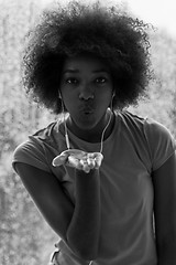 Image showing portrait of young afro american woman in gym while listening mus