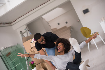 Image showing African American couple  playing with packing material