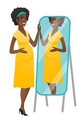 Image showing Pregnant woman looking at herself in a mirror.