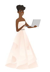 Image showing African bride in a white dress using a laptop.