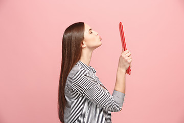 Image showing Businesswoman hugging laptop on pink studio