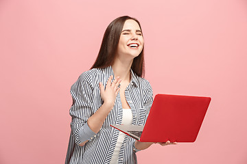 Image showing Businesswoman with laptop on pink studio